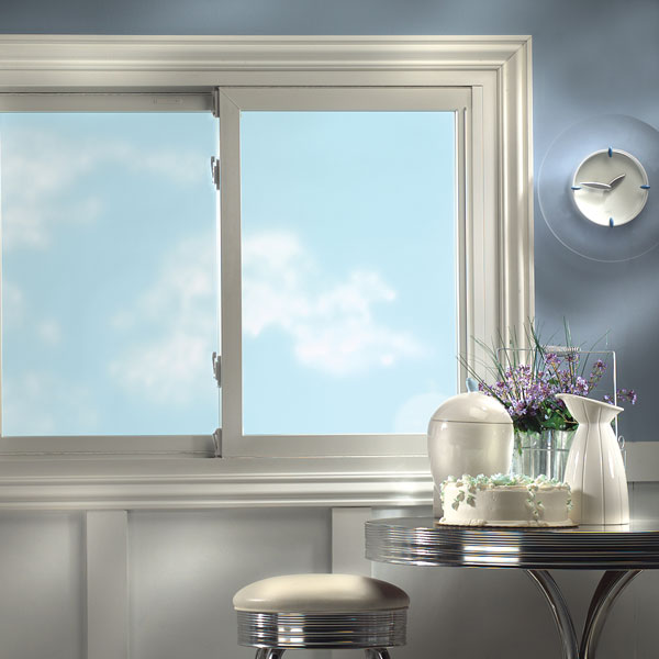 Modern kitchen with window and clock on wall.