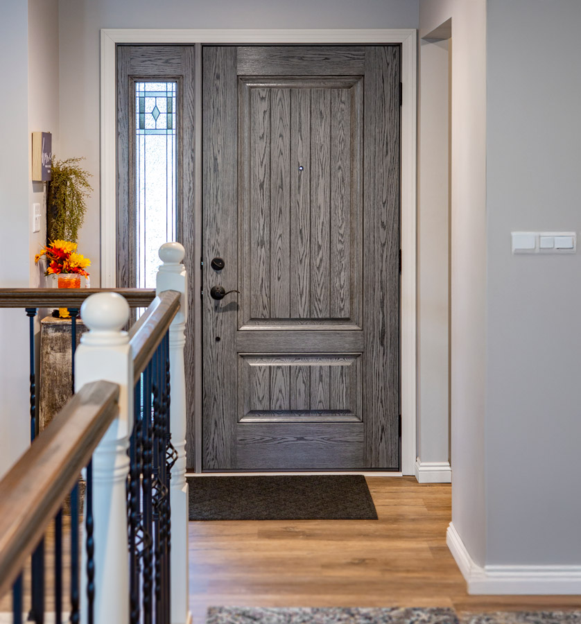 Elegant gray wooden front door with side window.