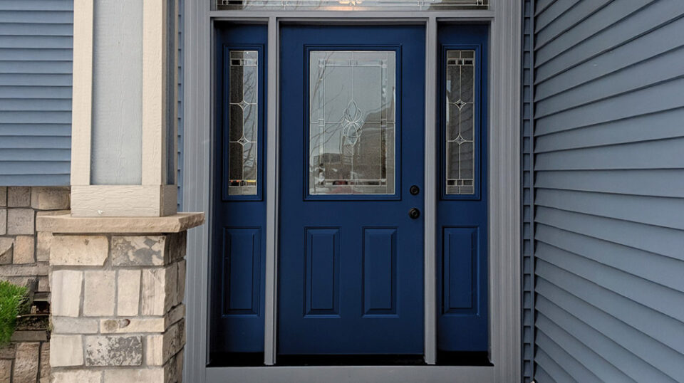 Blue front door with decorative glass panels.