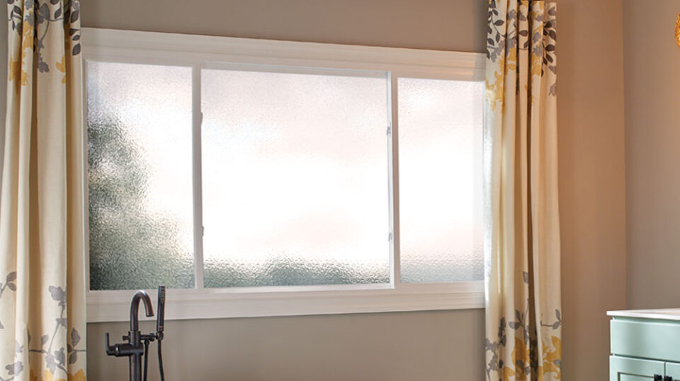 Frosted bathroom window with floral curtains