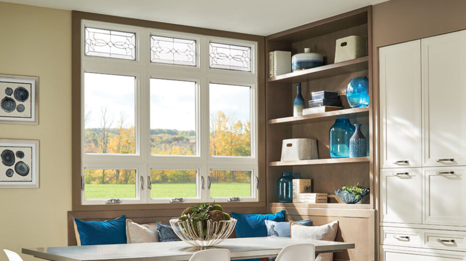 Bright dining area with shelving and large windows.