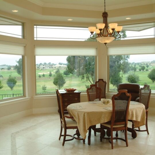 Elegant dining area overlooking golf course view.