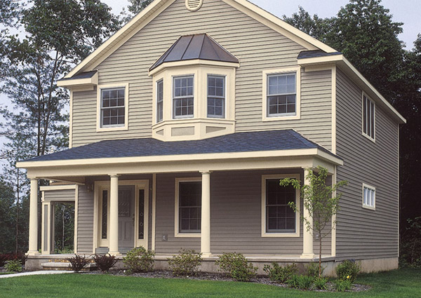 Two-story house with porch and bay windows.